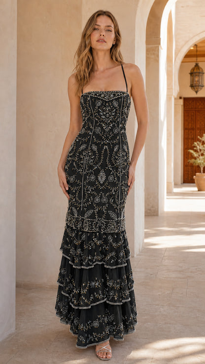 Front view of model wearing black beaded evening gown