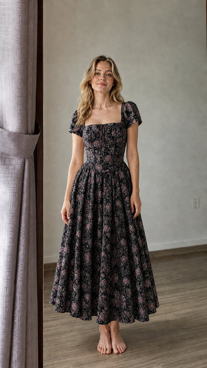 Woman wearing black floral midi dress