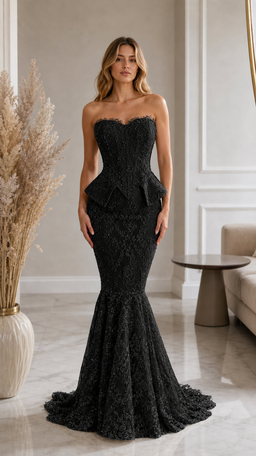 Front view of model wearing black strapless lace corset mermaid evening gown