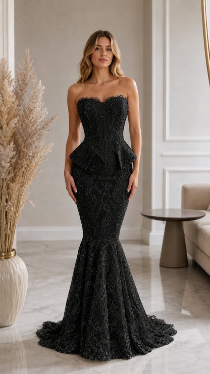Front view of model wearing black strapless lace corset mermaid evening gown