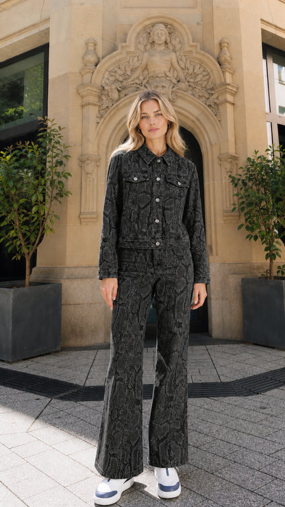 Full view of model wearing black snake print denim matching set