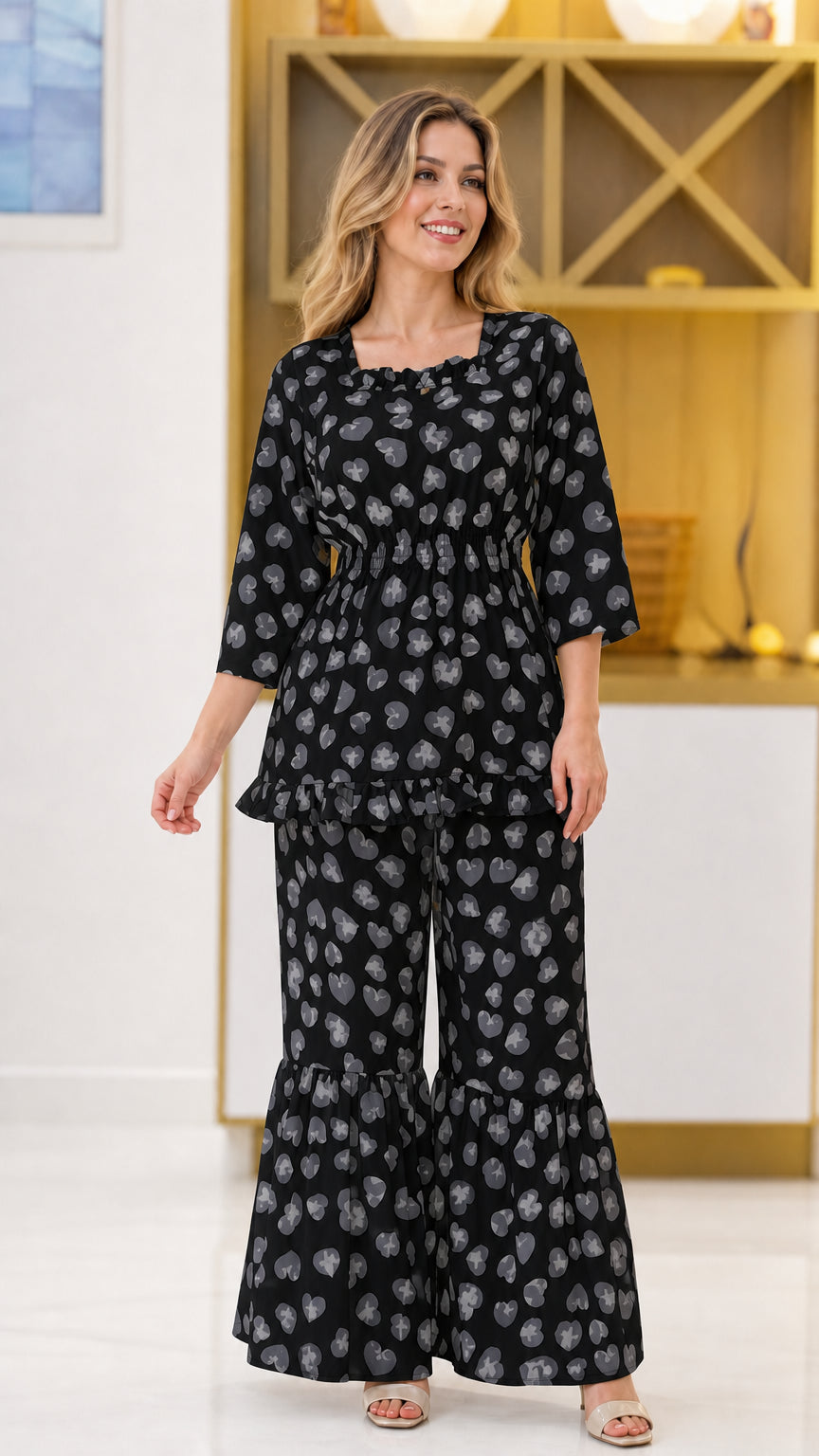 Black floral print 2-piece smocked top and flared pant set on model