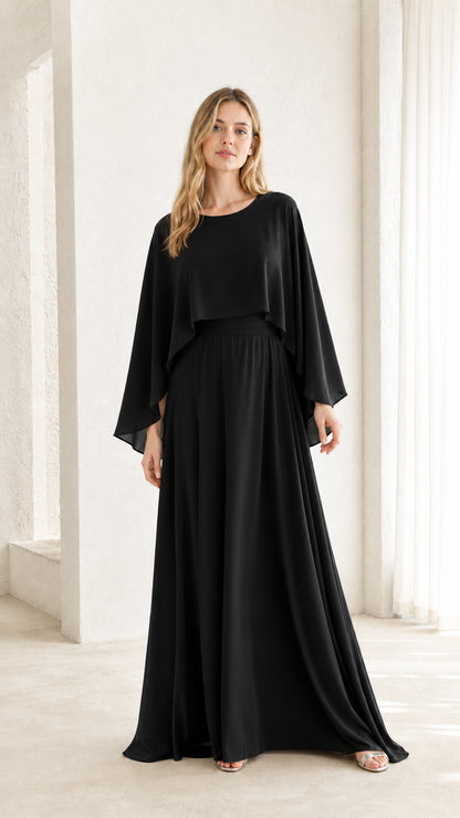 Woman wearing black cape overlay maxi dress