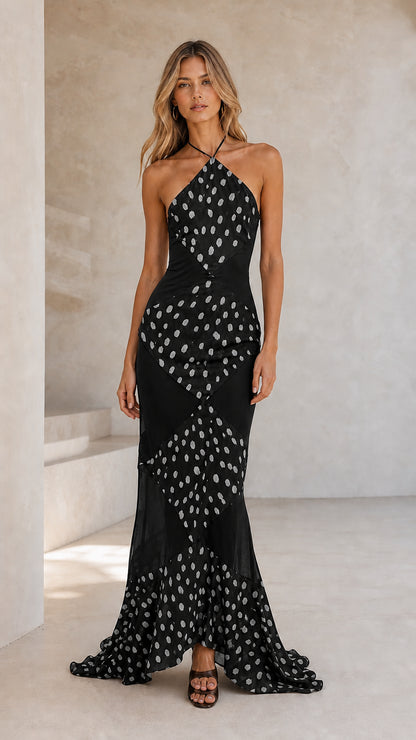 Front view of black halter polka dot maxi dress