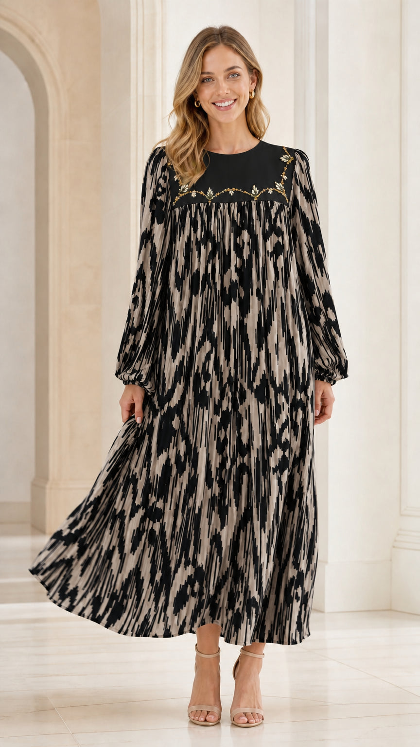 Woman wearing black and cream ikat pleated maxi dress with embroidered yoke
