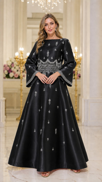 Front view of model wearing black beaded maxi dress
