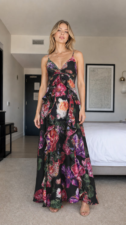 Model wearing black floral print ruffle maxi dress