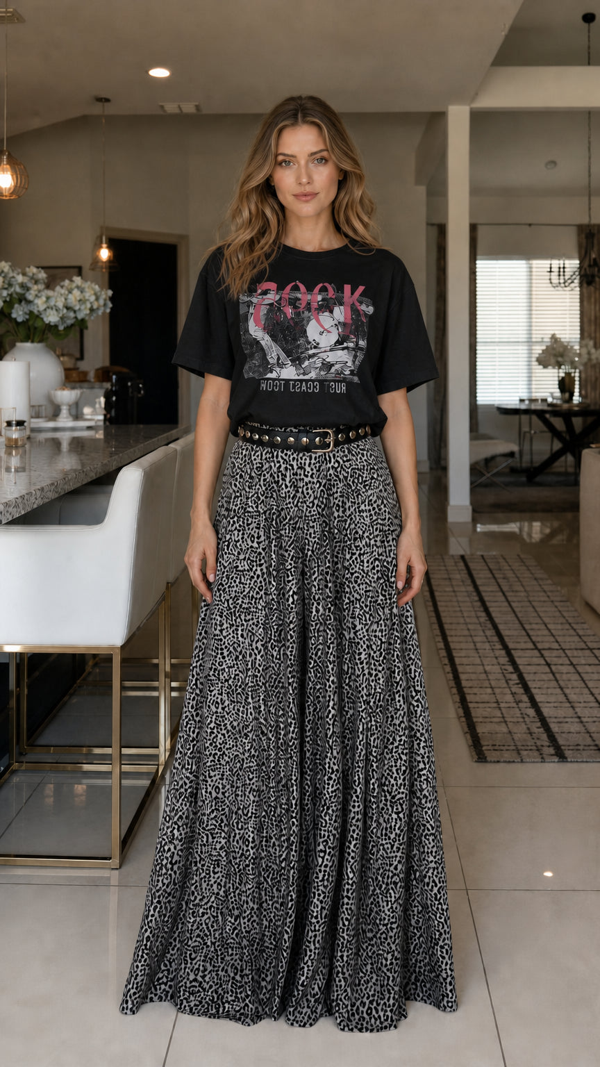 Model wearing black graphic tee and leopard print pants