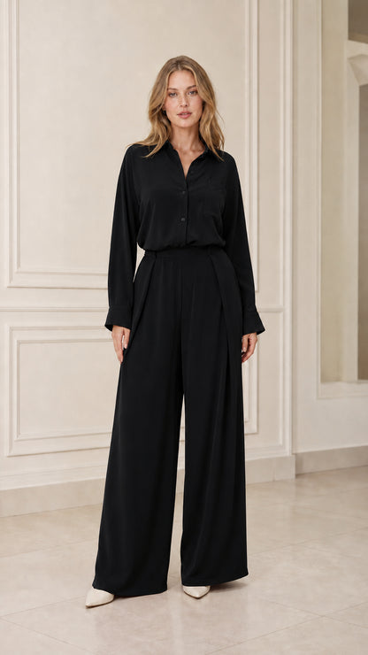 Model wearing black long-sleeve shirt and wide-leg trousers set