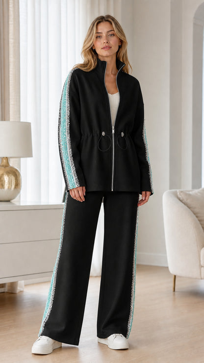 Full-length view of woman wearing black tracksuit set with sequin side stripes