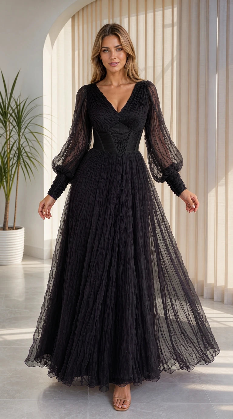 Front view of model wearing black corset tulle maxi dress with balloon sleeves