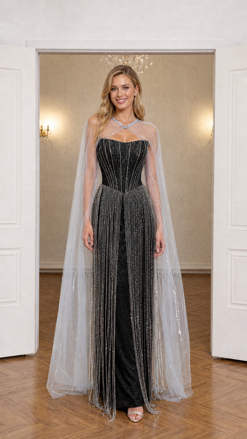 Front view of black beaded fringe evening gown with matching sheer cape