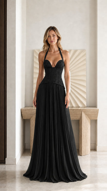 Front view of model wearing black halter lace corset pleated formal dress