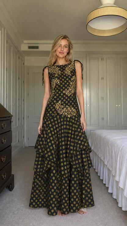 Model wearing black polka dot tiered maxi dress