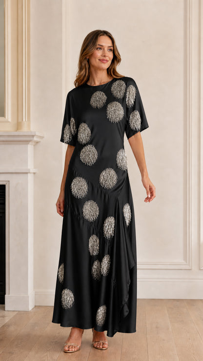 Model wearing black sequin polka dot satin maxi dress