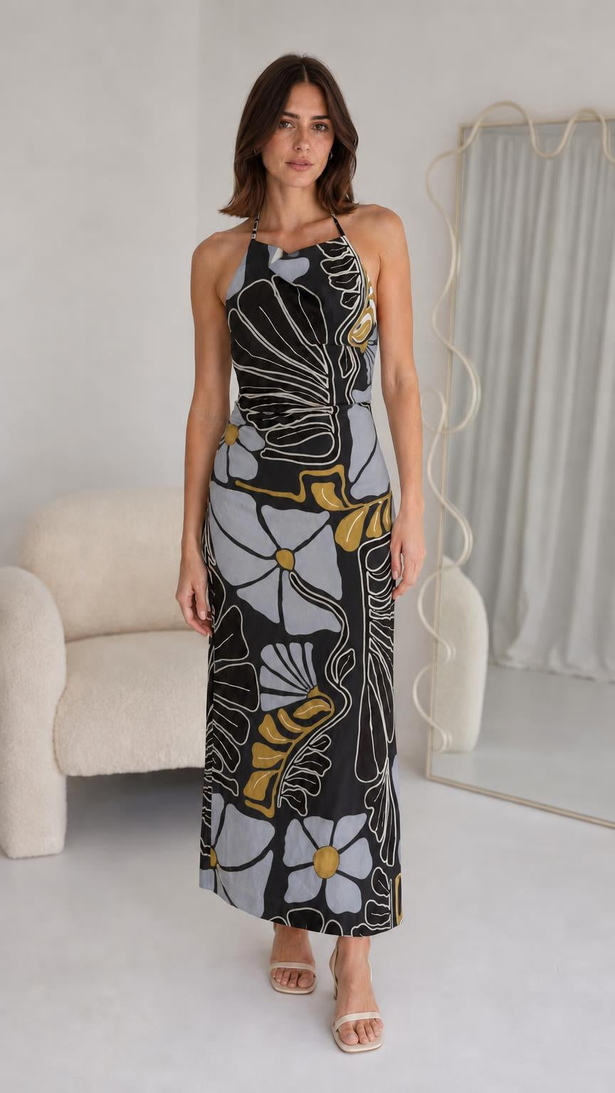Front view of woman wearing black floral halter maxi dress