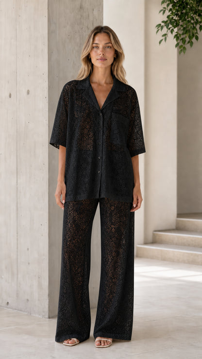 Front view of woman wearing black lace shirt and pants set