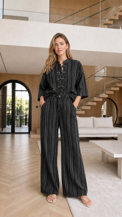 Model wearing black striped matching set