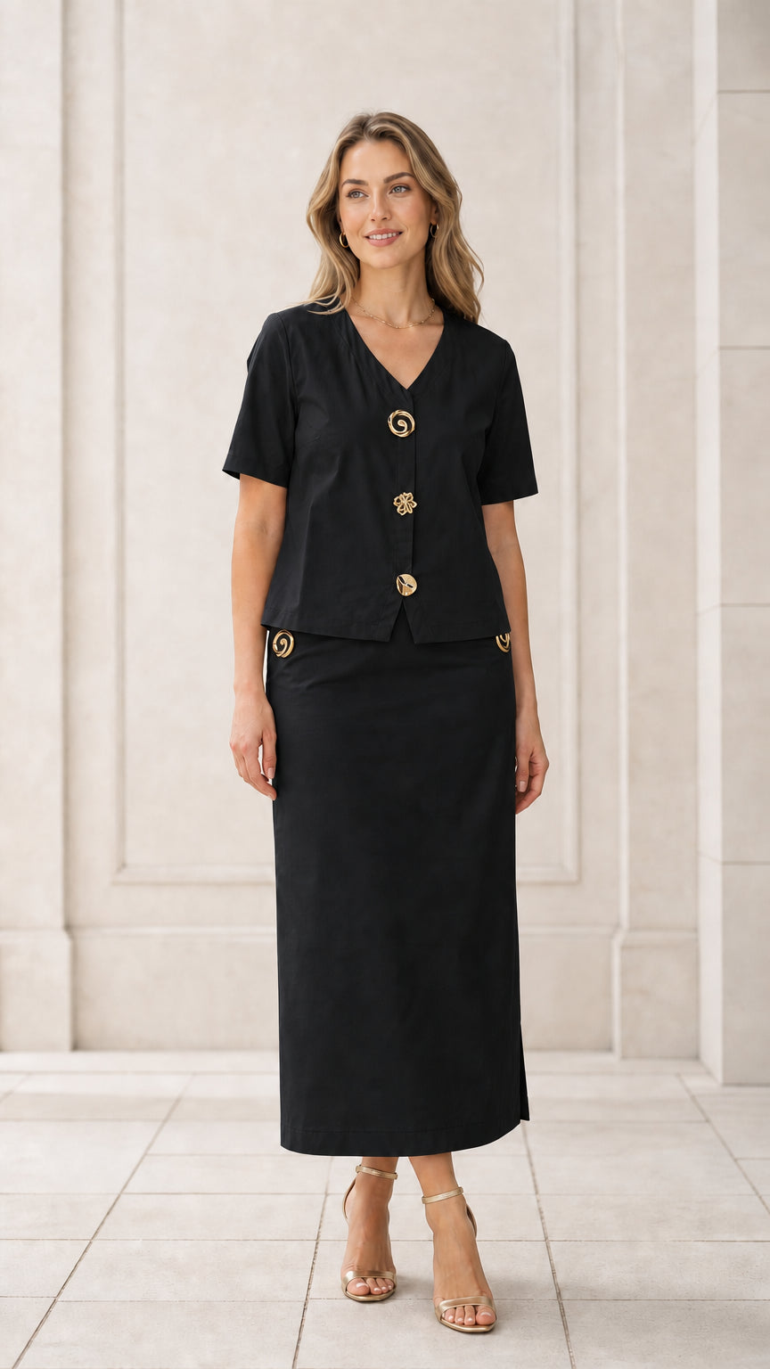 Front full view of woman wearing black short sleeve V-neck blouse and column maxi skirt set