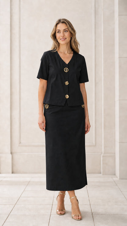 Front full view of woman wearing black short sleeve V-neck blouse and column maxi skirt set
