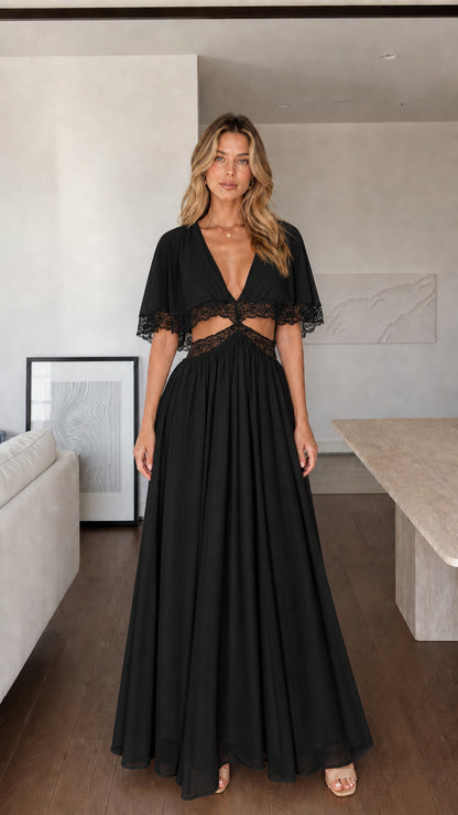 Front view of woman wearing black maxi dress with lace cut-outs