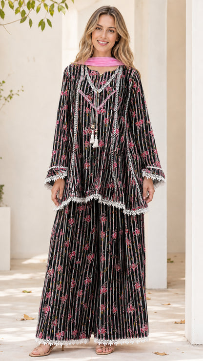 Model wearing black floral striped tunic and pants set