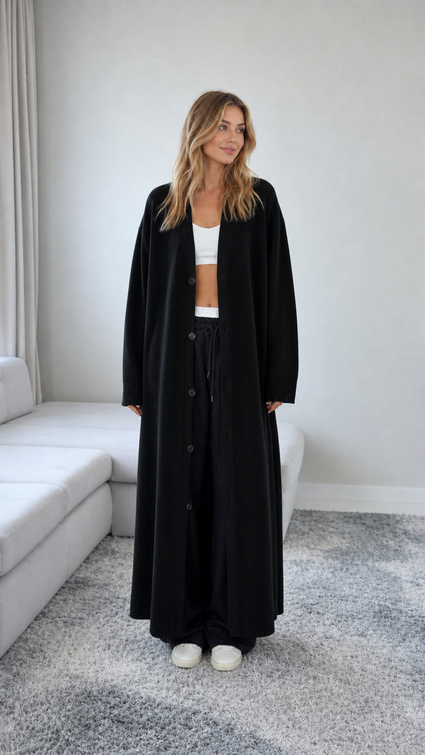 Front view of model wearing a Black floor length maxi duster cardigan