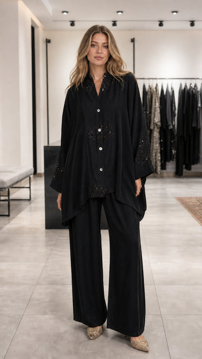 Model wearing black embroidered lounge set