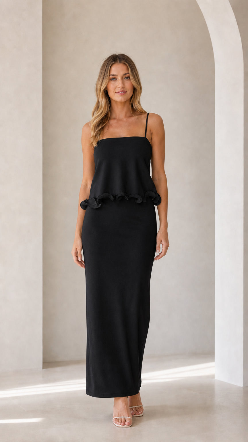 Model wearing black sleeveless ruffle trim maxi camisole dress