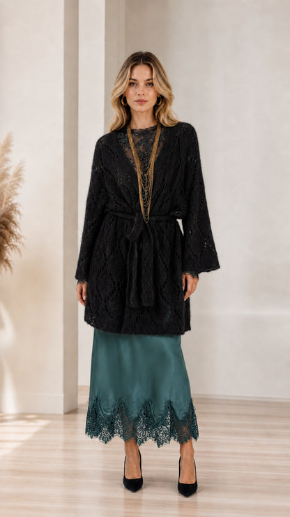 Model wearing black open front knit cardigan with belt