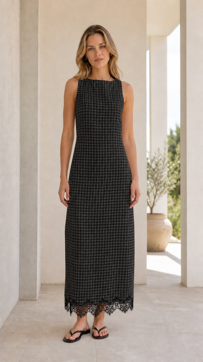 Front view of model wearing black gingham midi dress