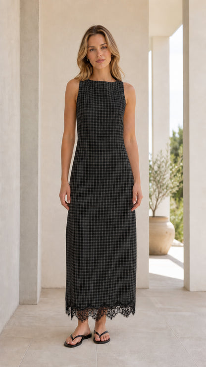 Front view of model wearing black gingham midi dress
