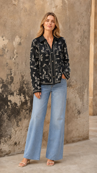 Black embroidered floral button-up blouse styled with light-wash jeans