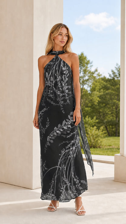 Full length view of model in black floral halter maxi dress