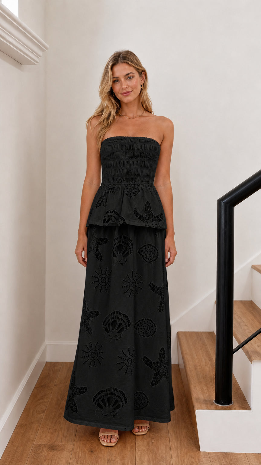 Model wearing black strapless embroidered maxi dress