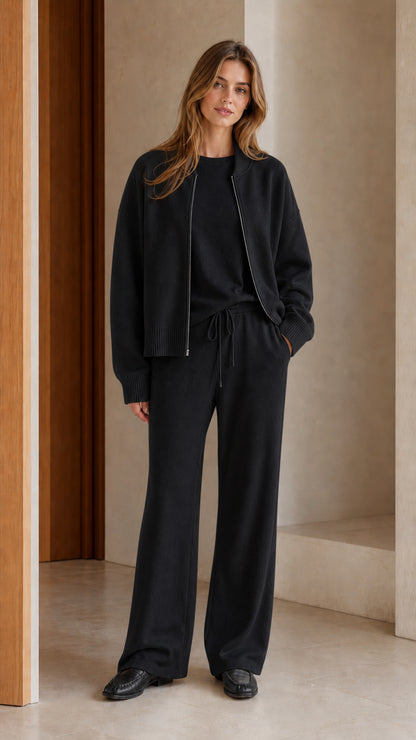 Model wearing black 3-piece knit zip-up cardigan and wide-leg lounge set