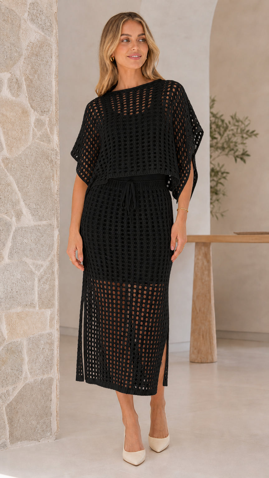 Model wearing black open-knit two piece skirt set