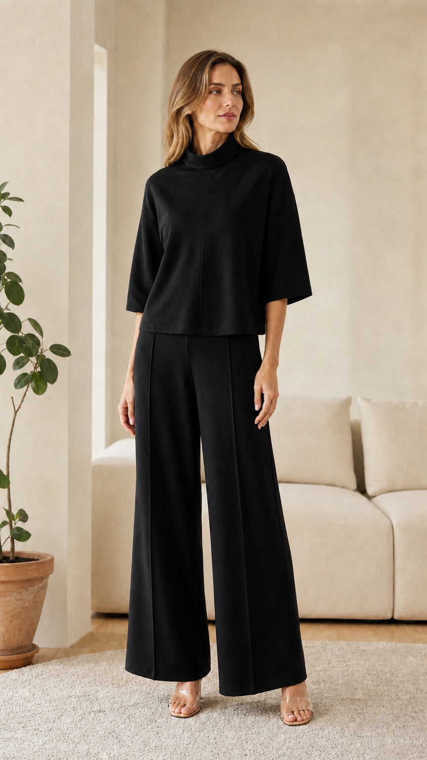 Woman wearing black lounge set matching top and pants