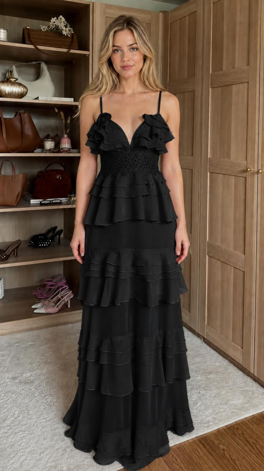 Front view of model wearing black ruffled tiered maxi dress