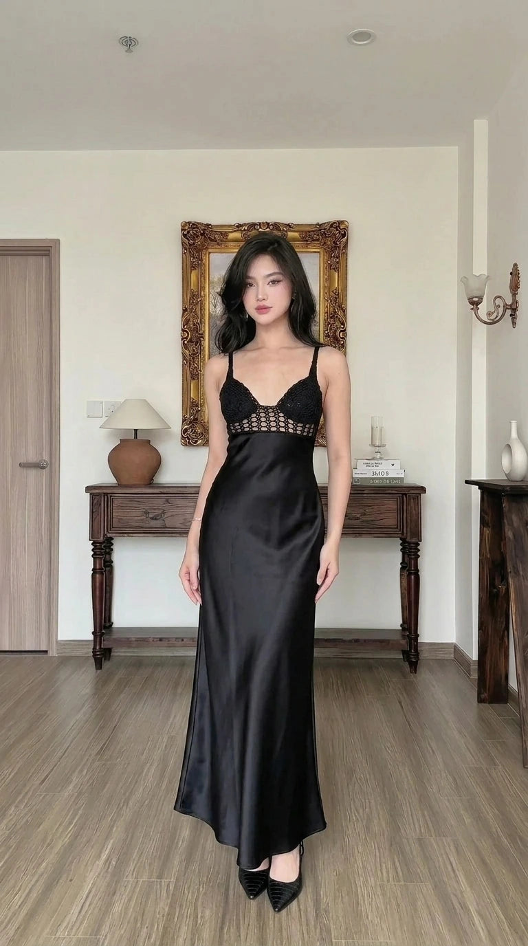 Woman wearing black satin maxi slip dress with crochet contrast