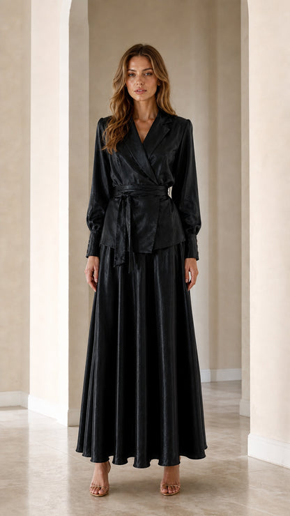 Front full view of woman wearing Black satin wrap blazer and maxi skirt two-piece set