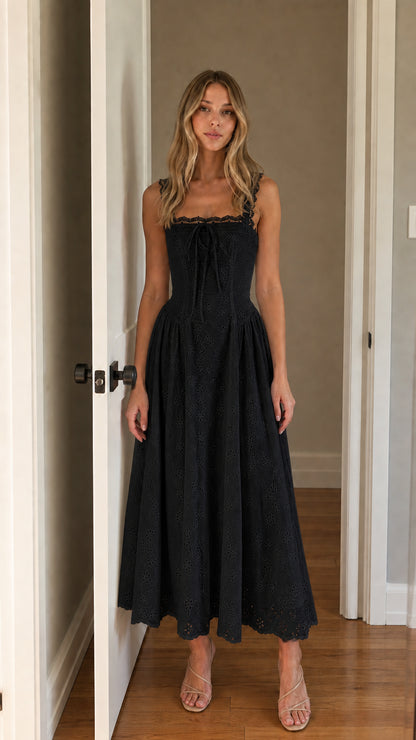 Front view of woman wearing black square neck eyelet midi dress