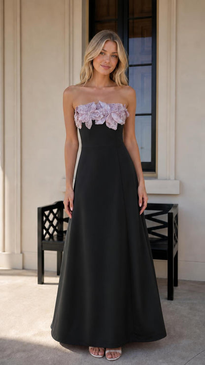 Model wearing black evening dress with floral bodice