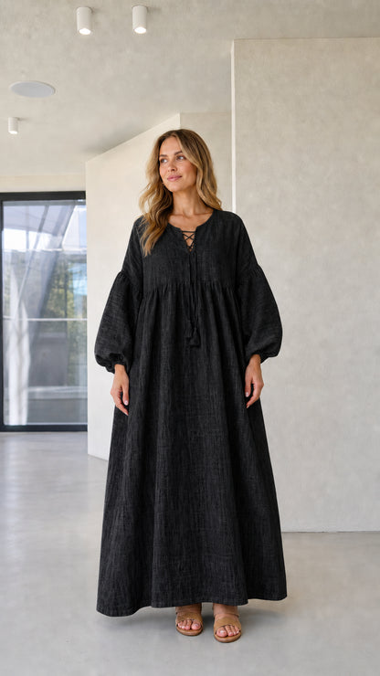 Model wearing black long balloon sleeve lace-up tassel maxi dress