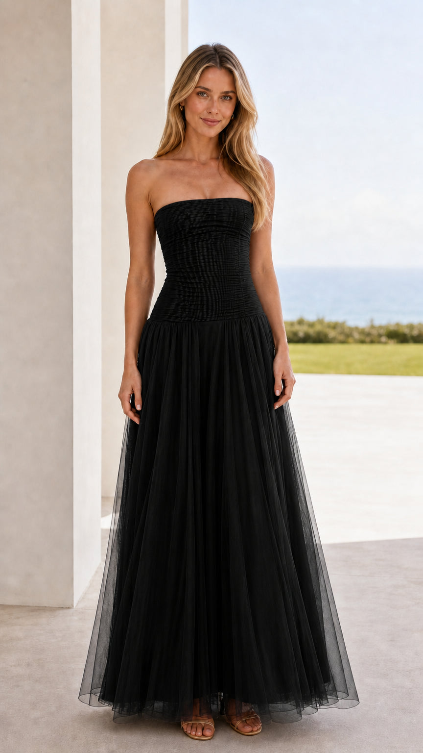 Front view of black strapless ruched tulle maxi dress