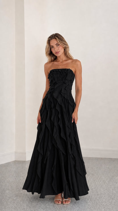 Full length view of black strapless ruffle maxi dress