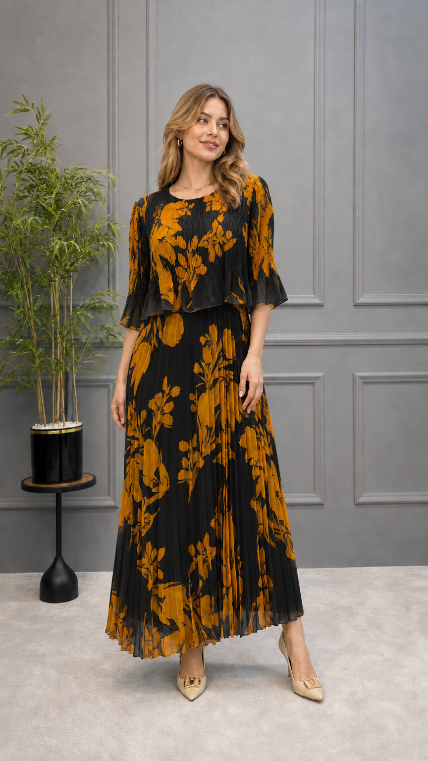 Model wearing black floral pleated maxi dress with tiered overlay top