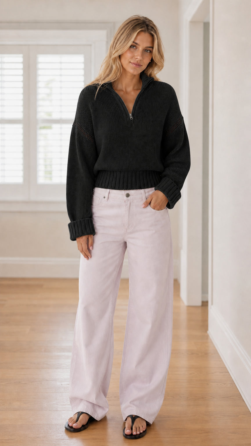 Model wearing black half-zip knit sweater