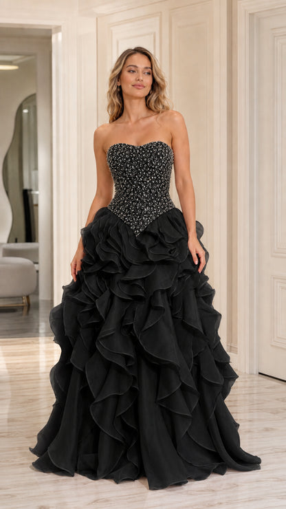 Model wearing black strapless beaded tiered ruffle ball gown