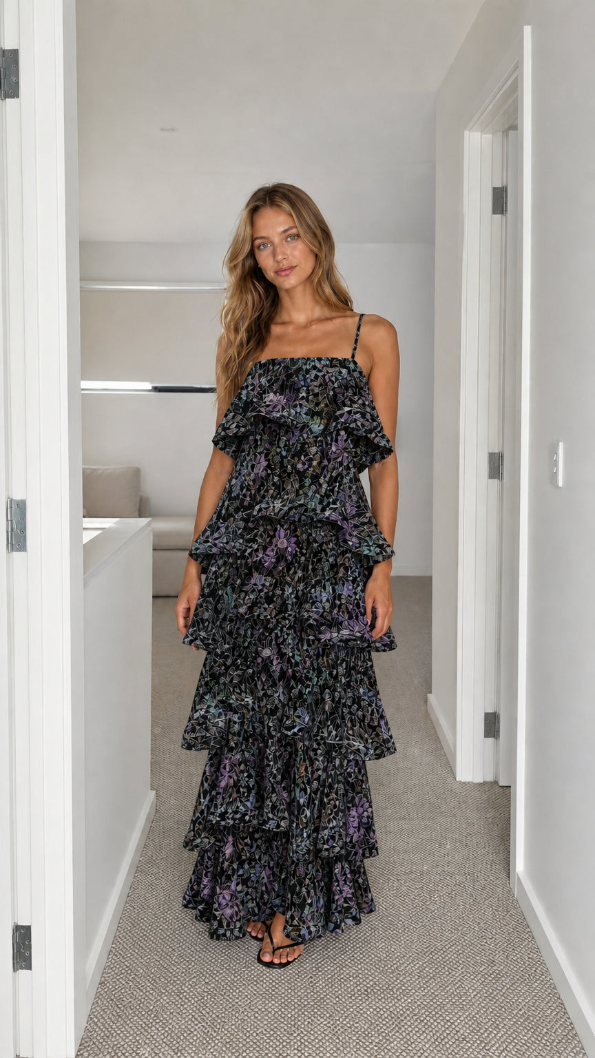 Front view of model wearing black floral tiered ruffle cami maxi dress